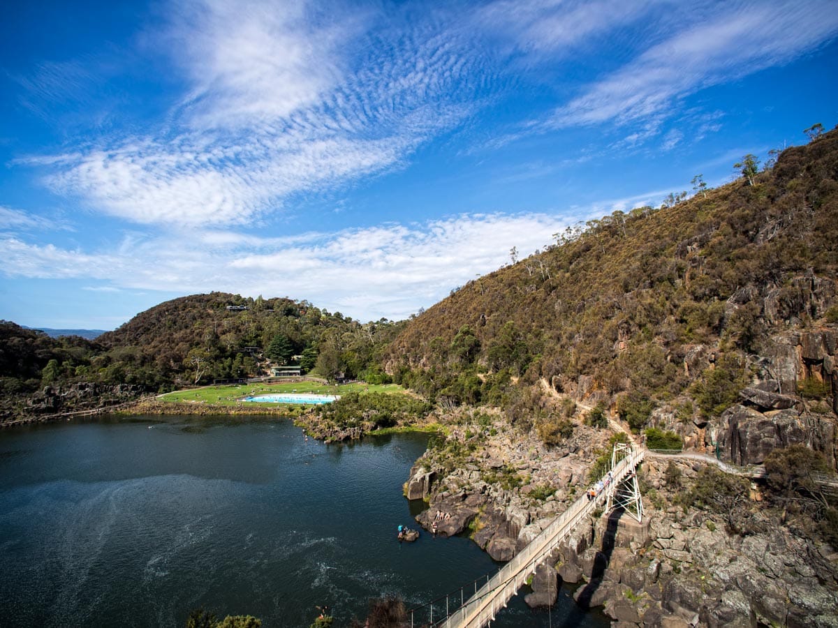 bridge overlooking a gorge with a swimming pool