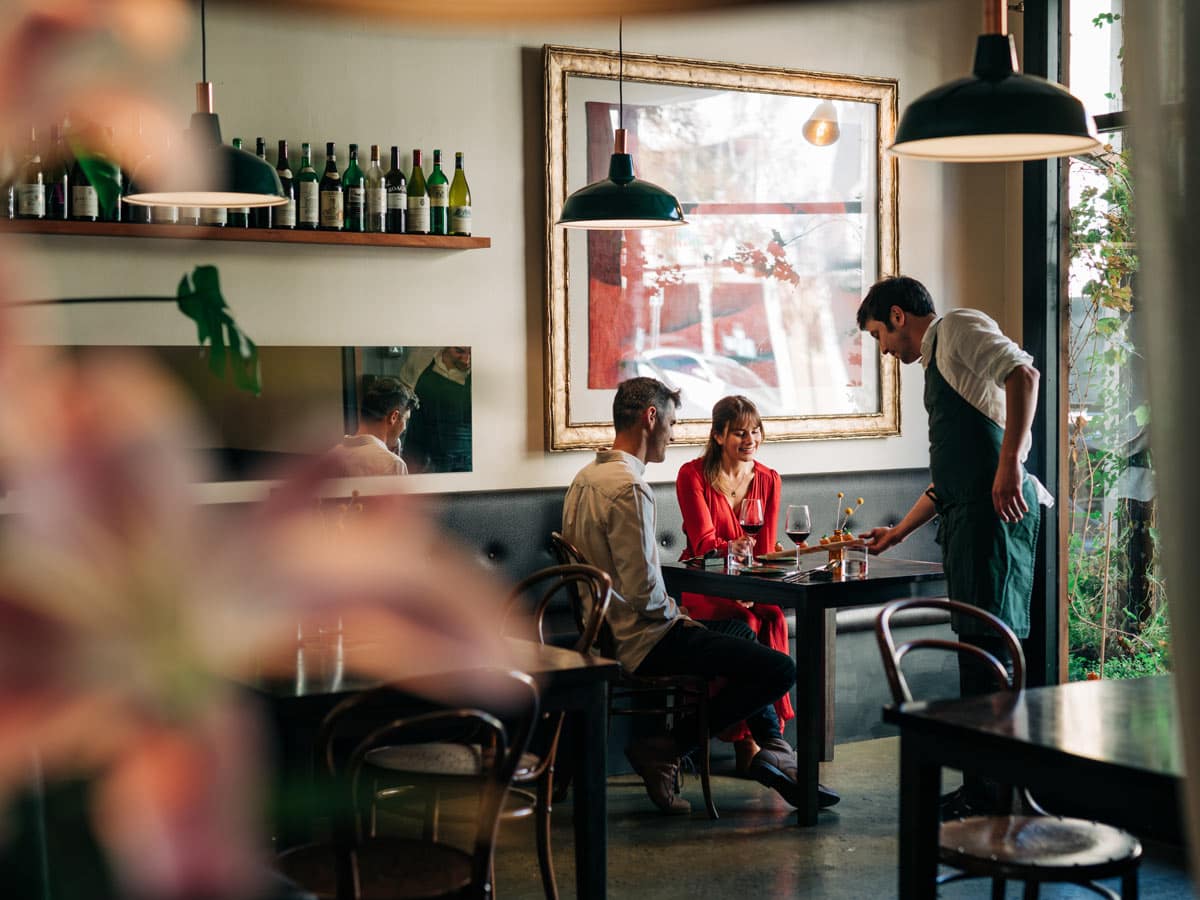 A couple being served at Fico restaurant in Hobart, Tasmania, Australia