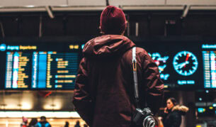 Person looking at flight schedule in airport