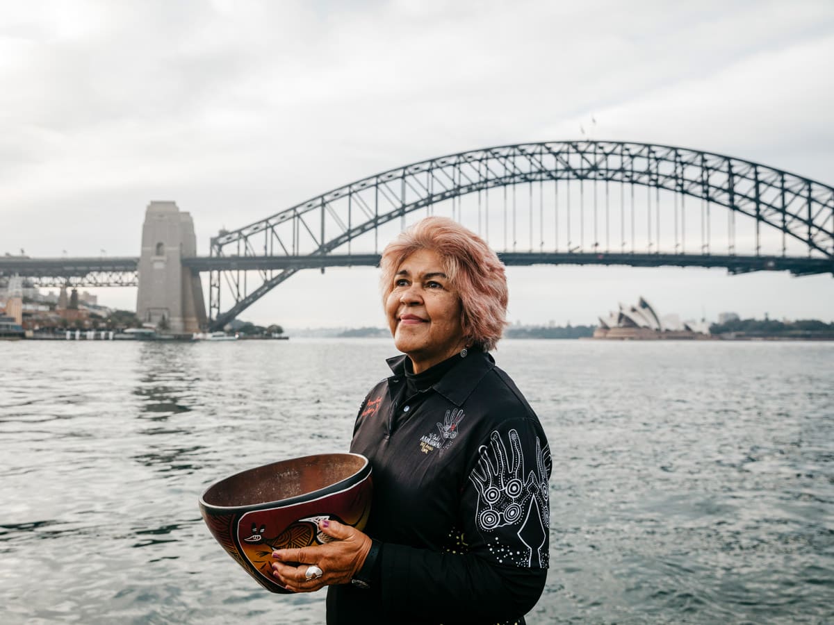 Margret Campbell standing in front of the Sydney Harbour Bridge. (Image: Destination NSW and Margret Campbell)