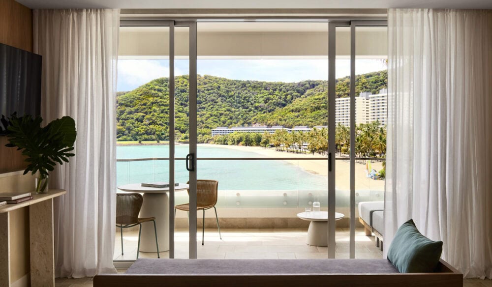 a sliding window looking out the balcony with beach views at The Sundays, Hamilton Island