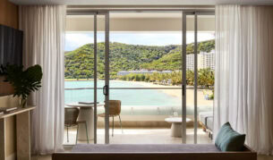 a sliding window looking out the balcony with beach views at The Sundays, Hamilton Island