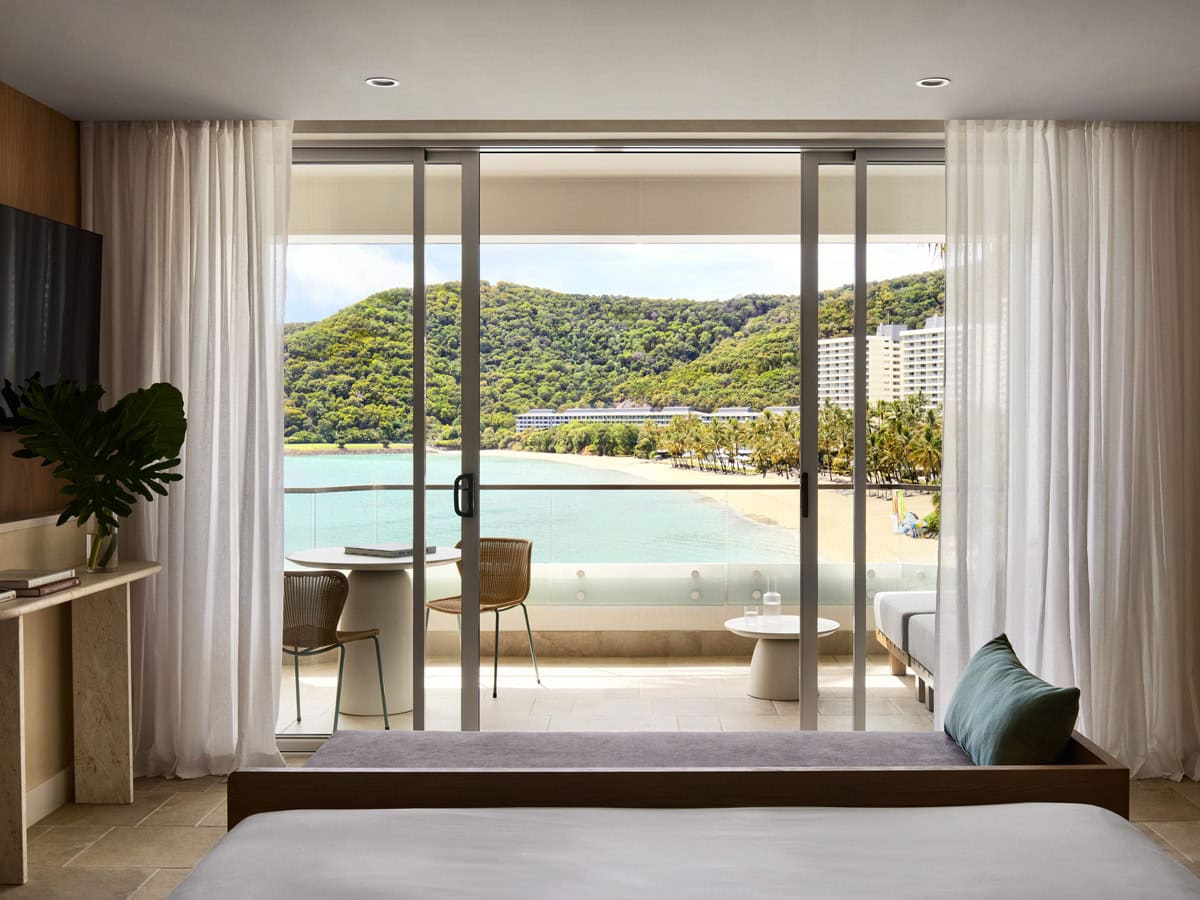 a sliding window looking out the balcony with beach views at The Sundays, Hamilton Island