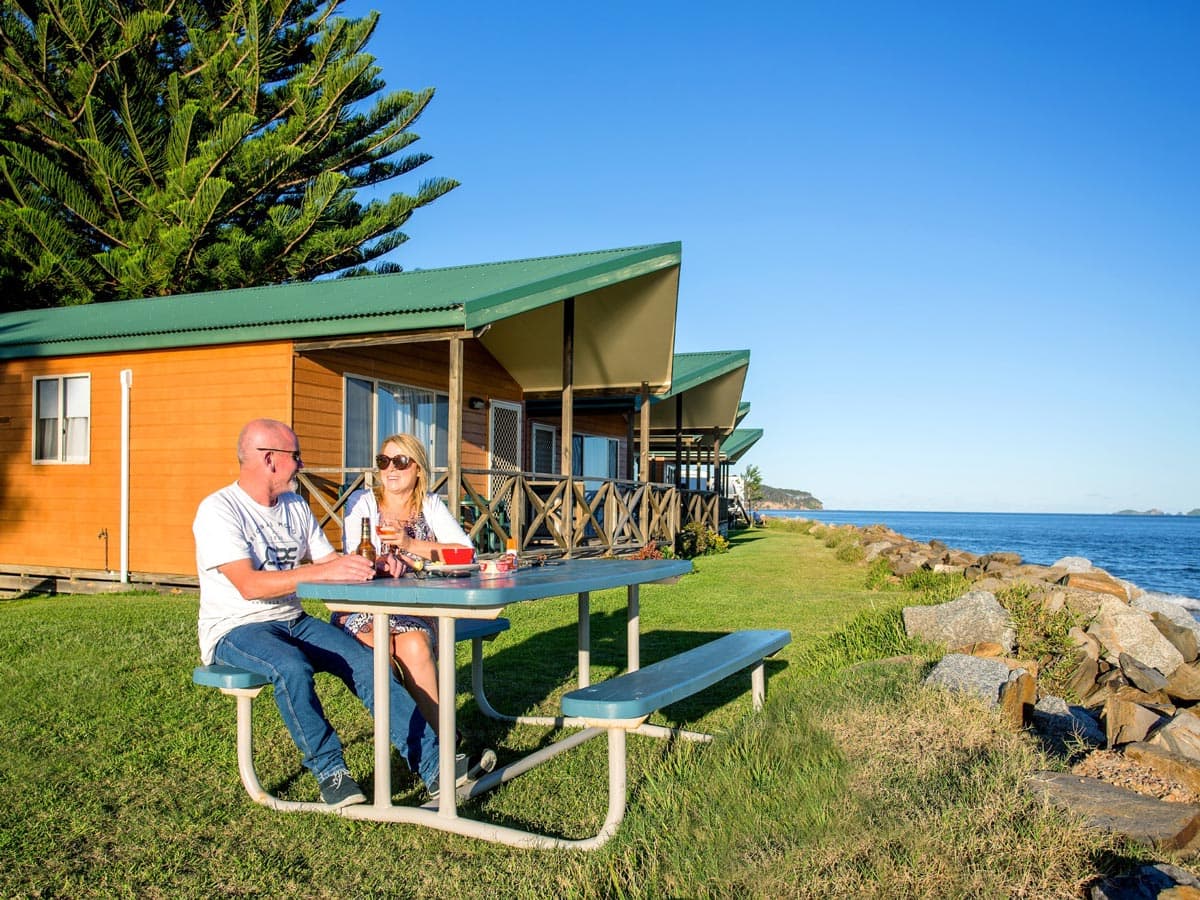 a couple al fresco dining at BIG4 Batemans Bay at East's Riverside Holiday Park