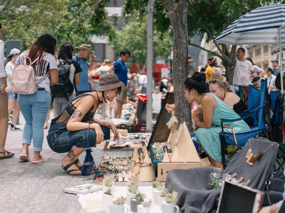 People crouching at Brisbane Suitcase Rummage