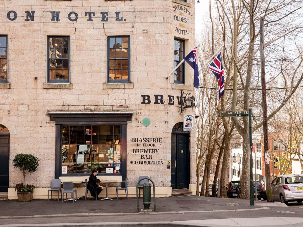 A patron sits out front of the Lord Nelson Pub in The Rocks.