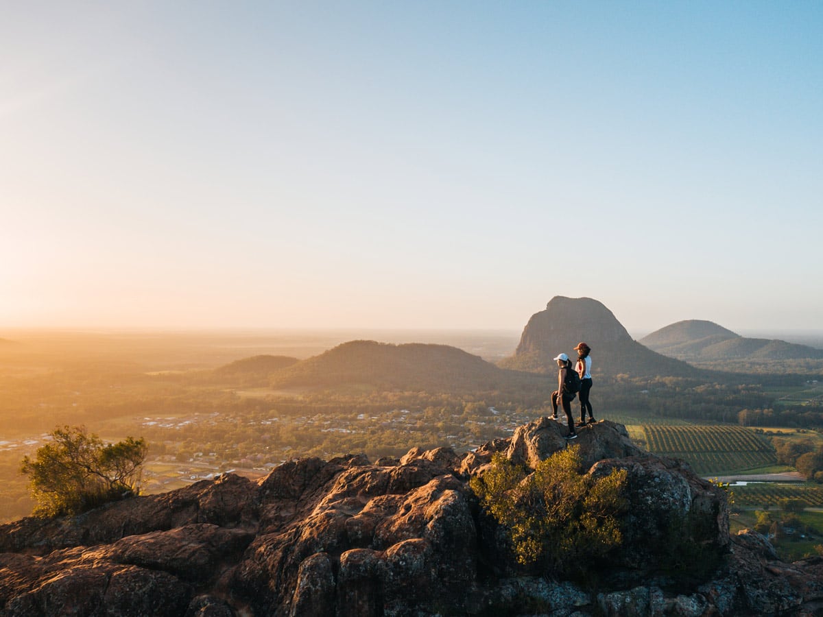 Standing at the top of Mount Ngungun at sunrise near Brisbane after hike