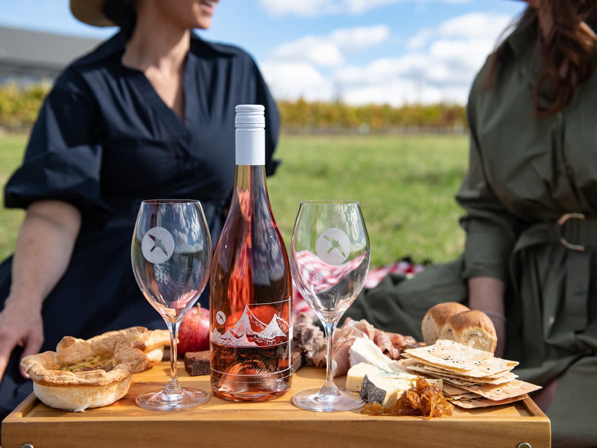 Two women enjoying a platter while on Printhie Helicopter Ultimate Winery Tour