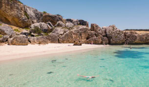 the white-sand shoreline and crystal clear waters of Stokes Bay