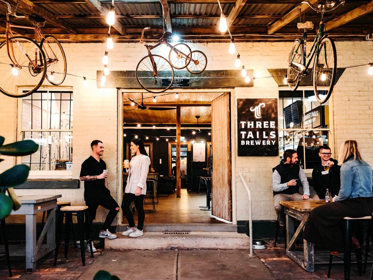 Patrons enjoying a drink at Three Tails Brewery